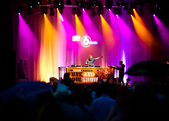 Craig Charles performing on stage at the River Festival