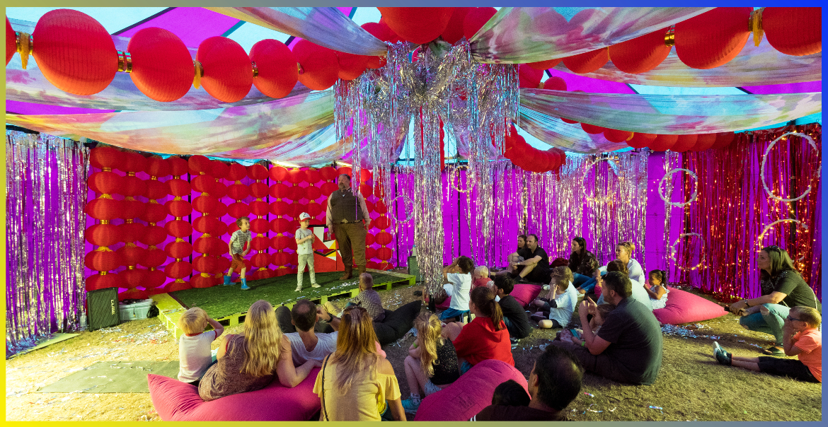 Children in a family tent at a festival.