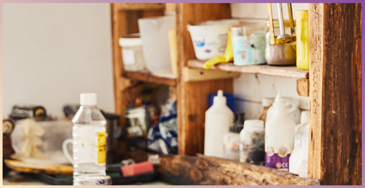 An image of an art studio with materials placed on shelves.