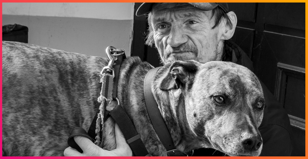 Black and white image of a man and a dog.