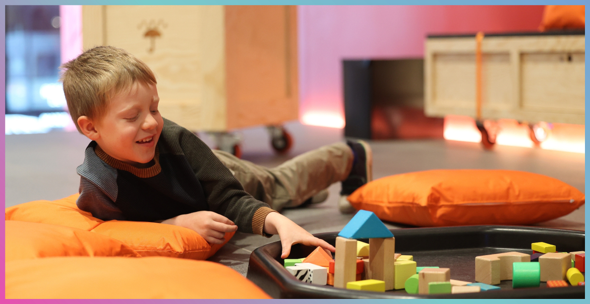 A young boy playing with building blocks.