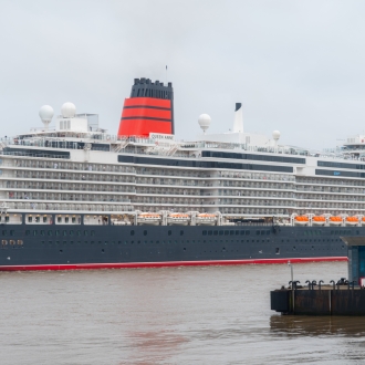 An image of Cunard Queen Anne ship docked in Liverpool on an overcast day.