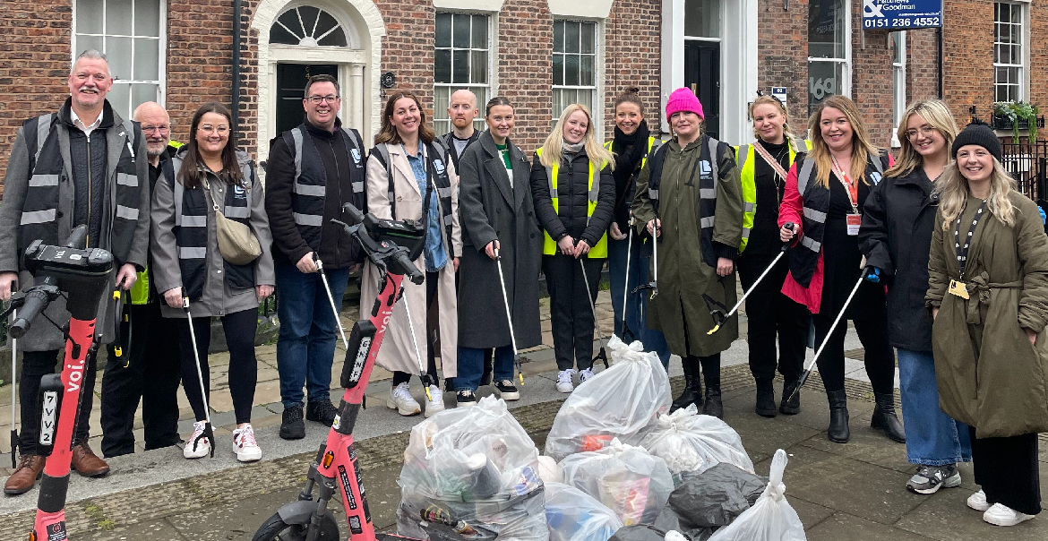 A large group of people litter-picking in the streets of Liverpool.