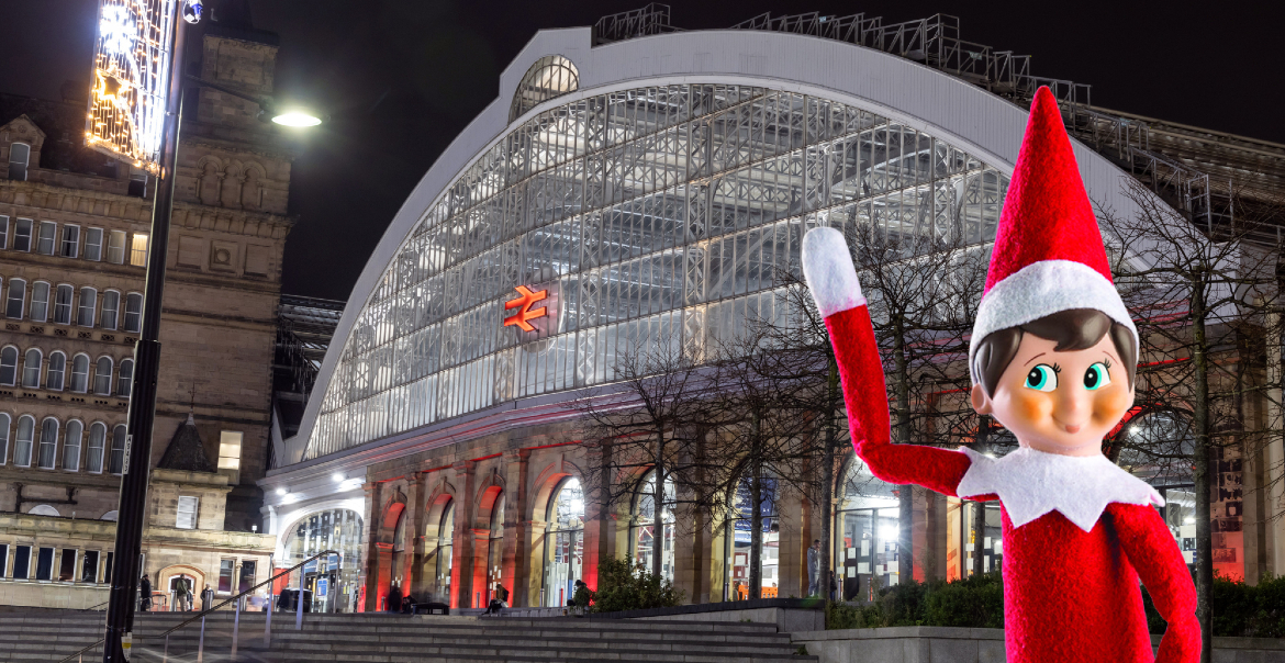 An image of the exterior of Liverpool Lime Street with an Elf on the Shelf character in front.