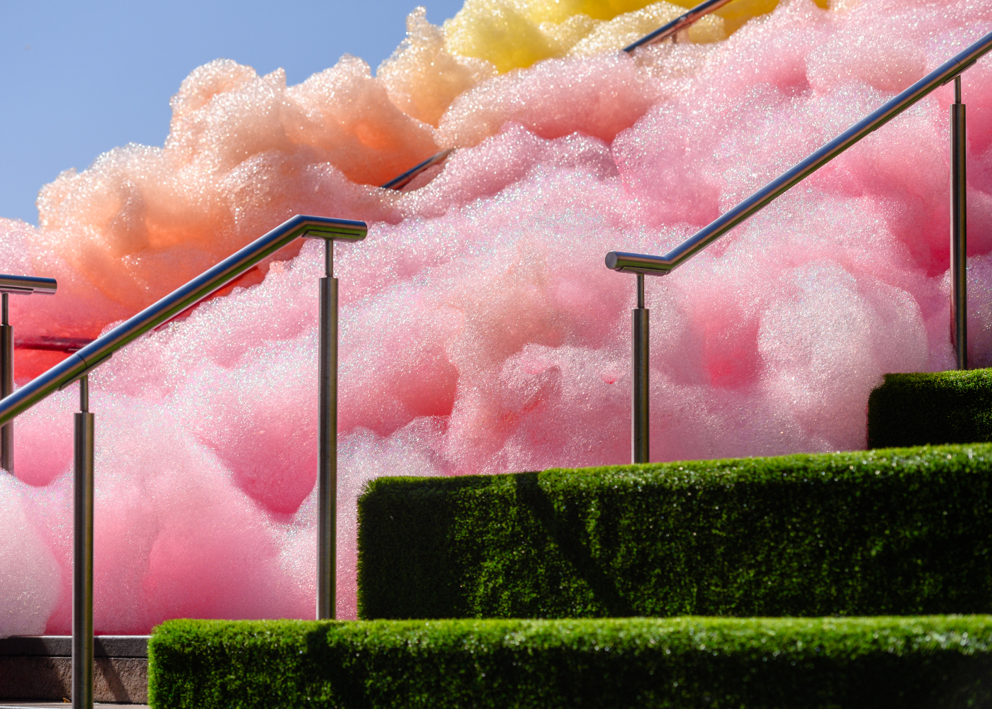 rainbow coloured bubbles flowing on grass covered steps