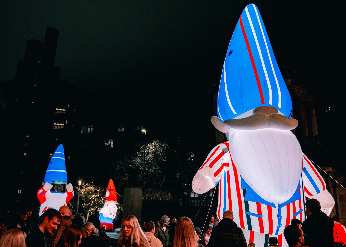 giant colourful gnomes glowing in the night