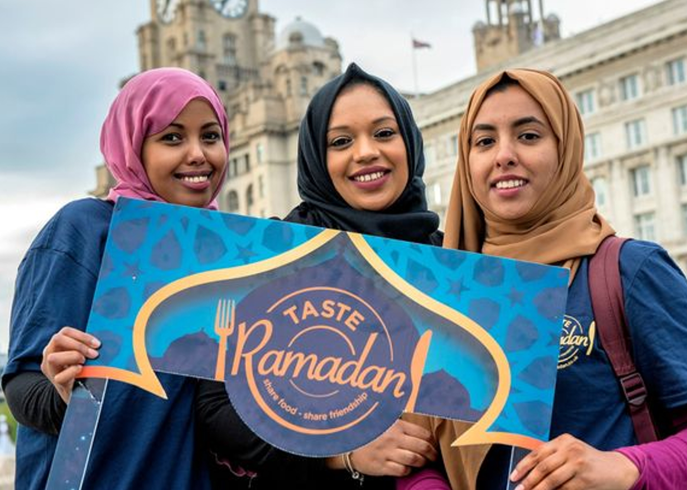 three ladies holding up a sign says Taste Ramadan