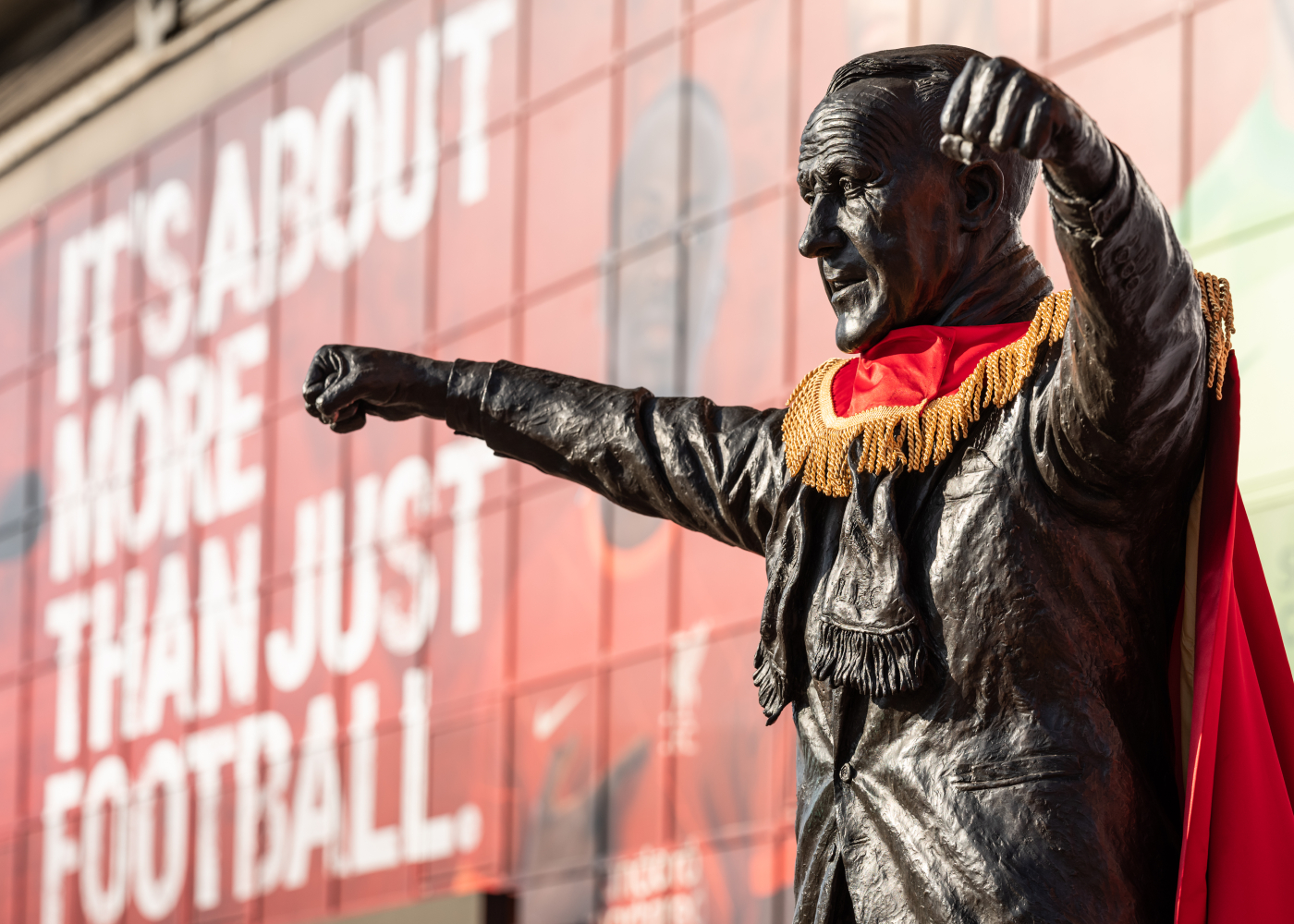 image of Bill Shankley statute in front of LFC with a red and gold hero cape