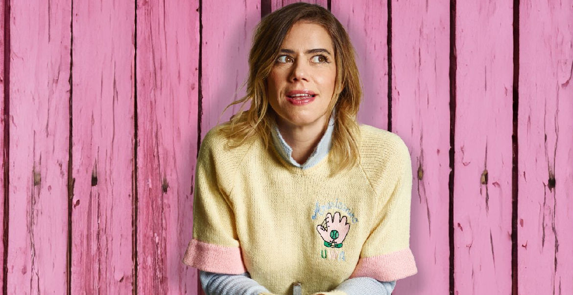 An image of Lou Sanders in front of a background of pink driftwood.