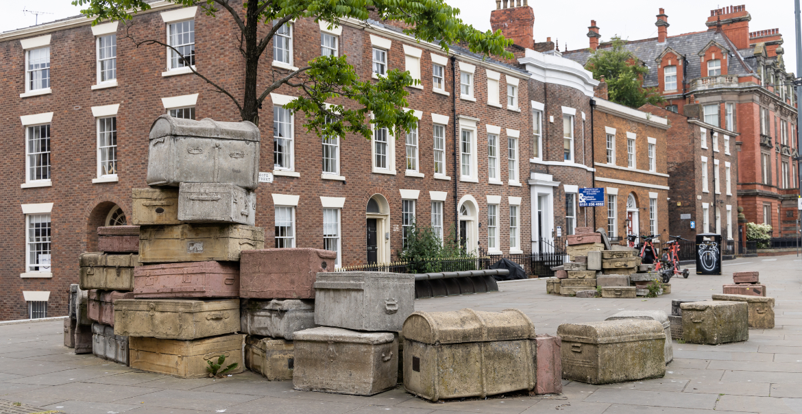 Outdoor street art composed of coloured concrete suitcases in a Georgian street